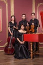 Classical music quartet posing after the concert. Royalty Free Stock Photo