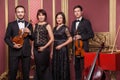 Classical music quartet posing after the concert. Royalty Free Stock Photo