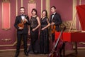 Classical music quartet posing after the concert. Royalty Free Stock Photo