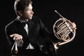 Classical musician portrait with French horn