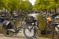 Classical old style bikes are chained to the metal railings of one of the bridges