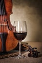 Classical old violin detail with red wine glass Royalty Free Stock Photo