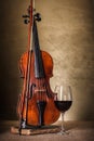 Classical old violin with red wine glass Royalty Free Stock Photo