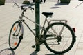 Classical retro bicycle parked on sidewalk, contrasting shadow on sunny day. Royalty Free Stock Photo