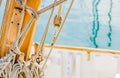 Classical sailing boat deck with rigging nautical ropes on wooden mast Royalty Free Stock Photo