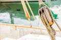 Classical sailing yacht deck, rigging wooden pulley and nautical ropes