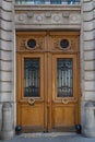 Aged wood double door entrance of old house in Paris France. Vintage wooden doorway and stone fretwork wall. Antique wood panels Royalty Free Stock Photo