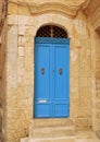 Classical style blue vintage double door on sand colour wall with stairs in Birgu, Malta