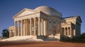 Classical-style rotunda building with tall columns, steps, and a large dome under a blue sky Royalty Free Stock Photo