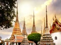 Classical Thai architecture in Wat Pho public temple at dramatic orange sunset sky , Bangkok, Thailand. Royalty Free Stock Photo