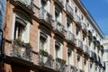 Classical vintage building facade with small elegant balconies in Chueca district dowtown Madrid Royalty Free Stock Photo