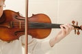 Classical Violin Closeup with Young Woman's Hand Playing on Strings