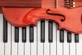 classical violin on white and black piano keys close-up background showing strings Royalty Free Stock Photo