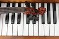 Classical violin on wooden piano keys. Classical violin on piano for music background concept. Holiday concert. Music concept