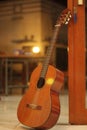 a classical wooden guitar propped against a wooden wall Royalty Free Stock Photo