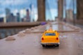 Classical yellow taxi model on an empty Brooklyn Bridge Royalty Free Stock Photo