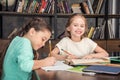 Classmates doing homework together in library