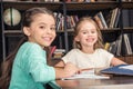 Classmates doing homework together in library