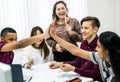 Classmates giving a high five teamwork and success concept Royalty Free Stock Photo