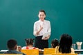 In classroom, Asian teacher teaches student