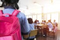 The classroom blur,Girl with red backpack Coming to the classroom Royalty Free Stock Photo