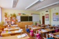 Classroom in a blurred background with no children. Students left their backpacks and notebooks and went on a break