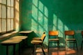 Classroom interior with chairs and desks near window and green wall with sunlight patterns cast on it Royalty Free Stock Photo