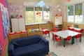 Classroom in a kindergarten with tables and chairs and blue sofa Royalty Free Stock Photo