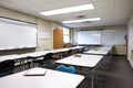 classroom with large whiteboard and markers, ready for lecture or demonstration