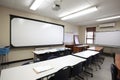 classroom with large whiteboard and markers, ready for lecture or demonstration