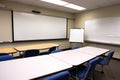 classroom with large whiteboard and markers, ready for lecture or demonstration