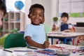 Classroom Portrait Of Smiling Male Elementary School Pupil In Art Class At  School Royalty Free Stock Photo