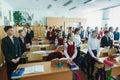 Classroom with pupils in school clothes with young attractive teacher in ukrainian school. School life,