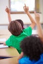 Classroom, raise hands and children rear for questions, education and language learning or quiz in school. Young group Royalty Free Stock Photo