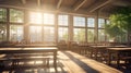classroom with sunlight streaming through large windows, highlighting empty desks and chairs
