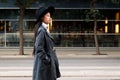 Classy asian woman walking in the city with hat Royalty Free Stock Photo