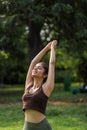 Classy Beautiful Woman In Gym Outfit Performing Surya Namaskar Exercise In Park