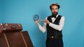 Classy bellhop poses with wall clock