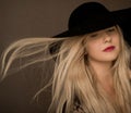 Classy blonde woman wearing a hat, artistic film portrait for fashion campaign and beauty brand Royalty Free Stock Photo