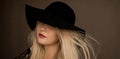 Classy blonde woman wearing a hat, artistic film portrait for fashion campaign and beauty brand Royalty Free Stock Photo