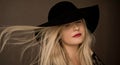 Classy blonde woman wearing a hat, artistic film portrait for fashion campaign and beauty brand Royalty Free Stock Photo