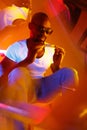 Cinematic portrait of handsome young man in neon lighted room, stylish musician