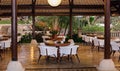 Classy elegant and modern restaurant at beach resort in Bali Indonesia. Seats, tables and lamps at luxury premium hotel.