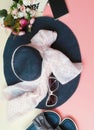 Woman Accessories hat handbag scarf perfume black Sunglass Beautiful Flowers Roses on pink and white background Royalty Free Stock Photo