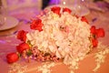 Classy floral arrangement in a pastel oval bouquet featuring pink hydrangeas and red roses