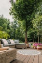 furniture on wooden terrace in green beautiful garden Royalty Free Stock Photo