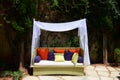 Classy Garden Furniture with Colourful Pillows and White Sheets