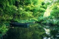 Claude Monet in autumn garden, boat in the lake among the bamboo groves