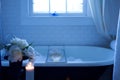 Bubble bath soak with tea, candles and flowers Royalty Free Stock Photo