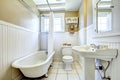 Claw foot tub in white bathroom